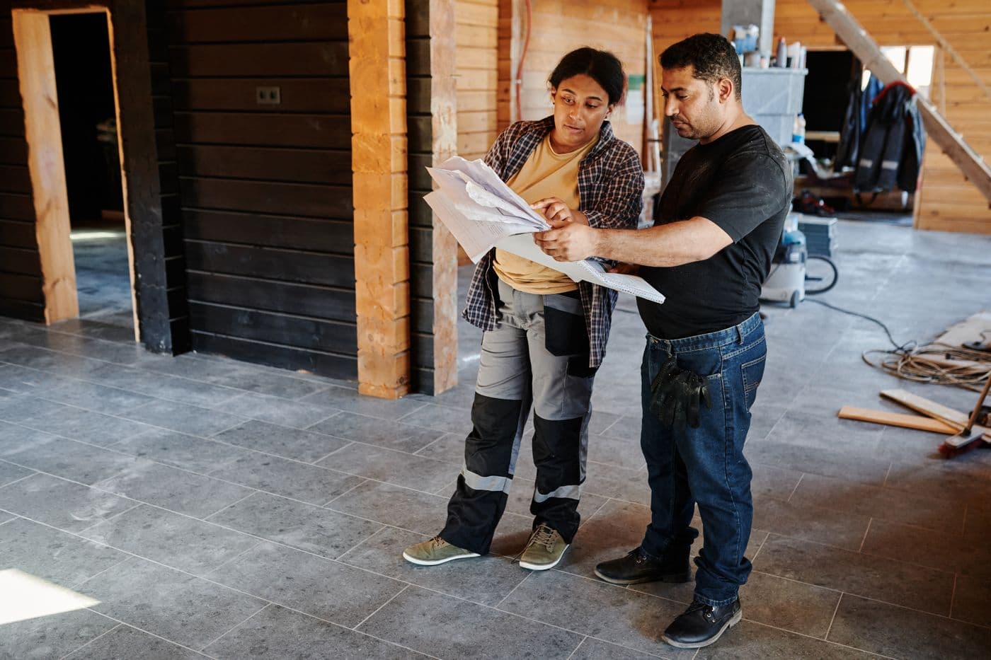 Construction team reviewing plans inside an active project site