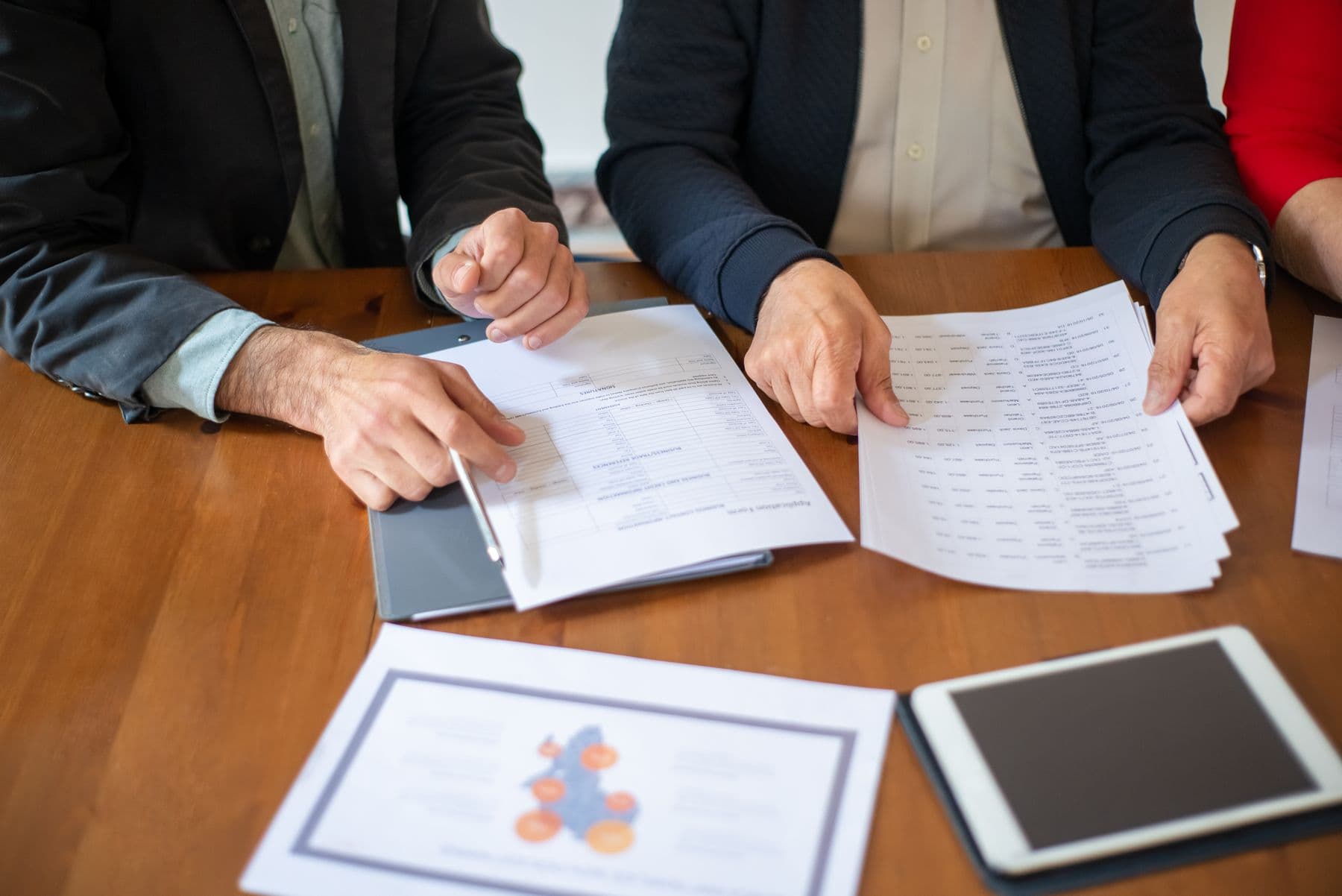 Operations team reviewing documents around a meeting table